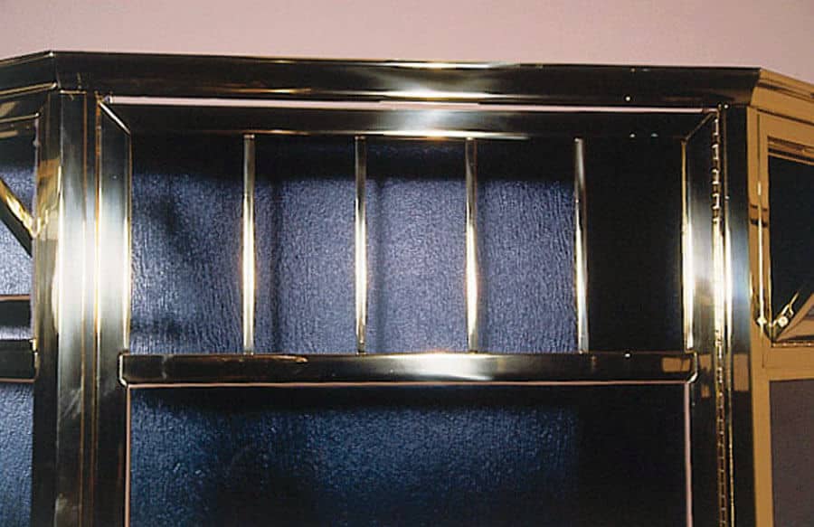 shower door hardware closeup of brass framed transom