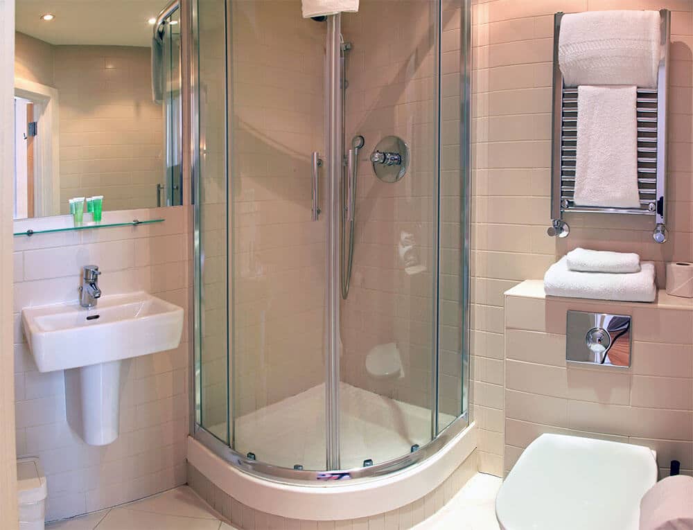 Half-Round Corner Shower Door half-round corner glass shower door in small luxury bathroom