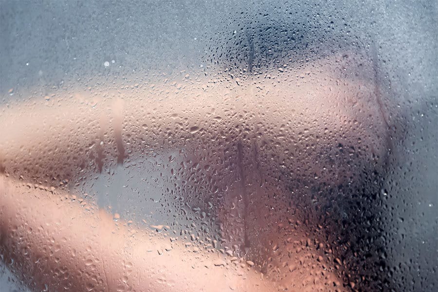 woman through frosted shower glass