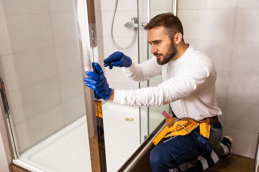 Professional vs DIY Shower Door Installation: Pros and Cons 3 diy shower door installation man installs shower door enclosure